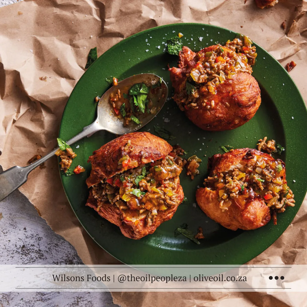 Recipes 11 Curried lamb mince served with amagwinya on a plate