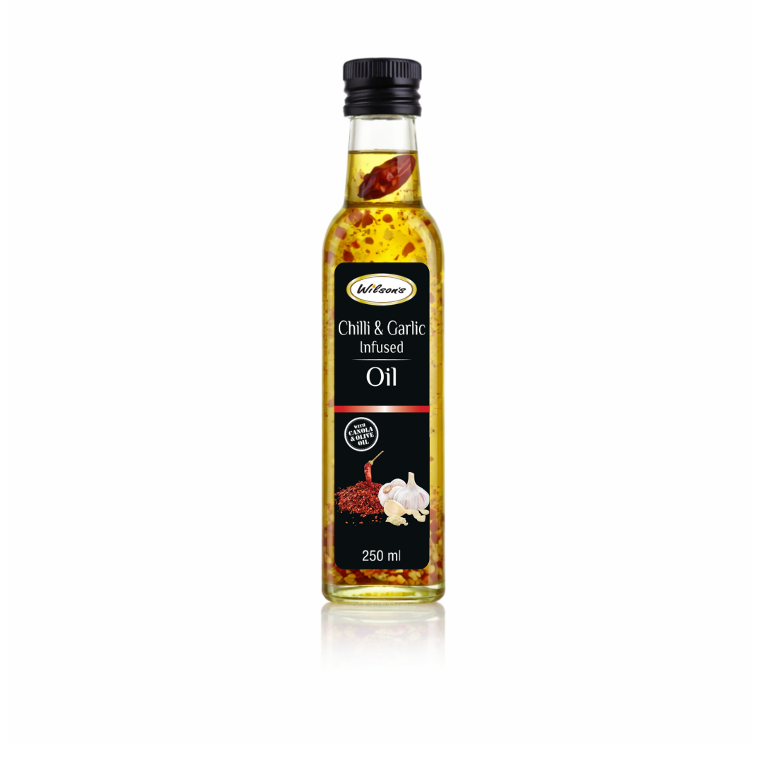 Wilson's Garlic & Chilli Infused Oil 1 Wilson's Foods Garlic & Chilli Infused Oil 250ml bottle with visible garlic pieces and chilli flakes