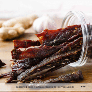 Balsamic cured beef jerky laid out on a wooden board