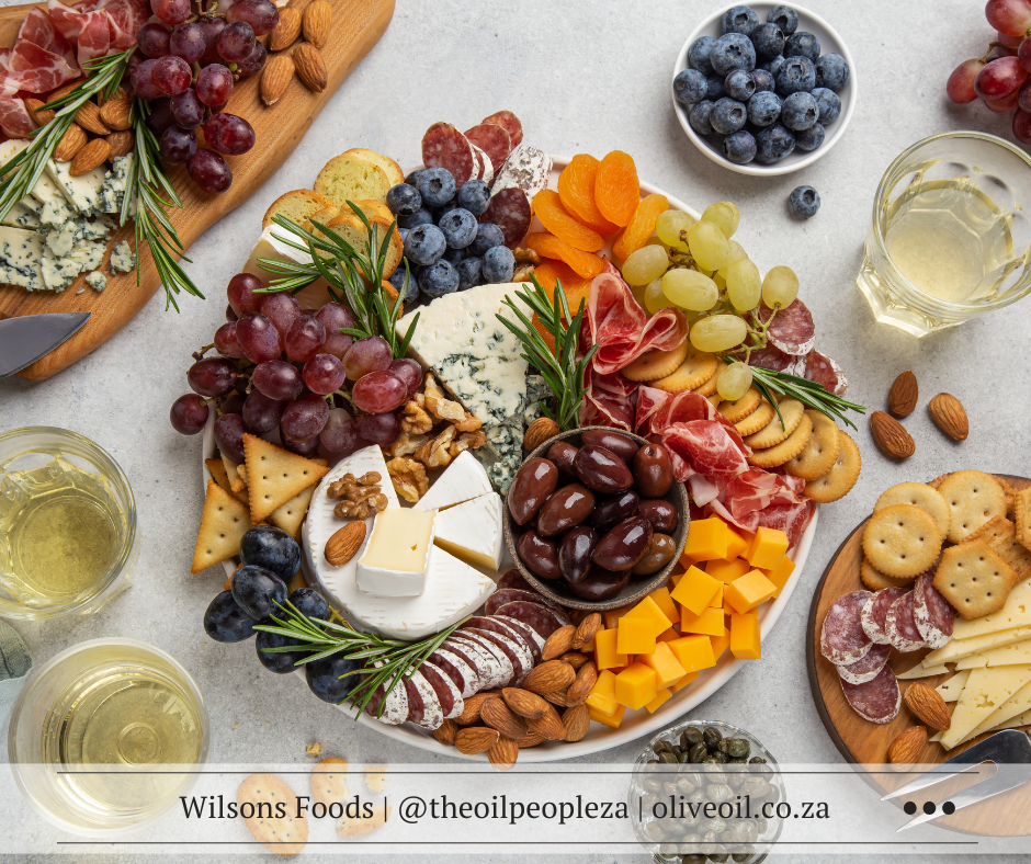 The perfect charcuterie board with cheeses, cured meats, olives and olive oil dip