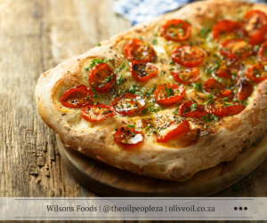 Three flavour focaccia bread with balsamic onion, tomato basil and cheese toppings, drizzled with Wilson's Extra Virgin Olive Oil