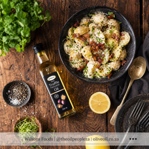 Creamy braai potato salad with crispy bacon and spring onions drizzled with Wilson's Foods White Truffle Oil