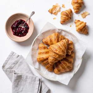 Sugar Bean Curry 1 Golden baked Croissants with visible flaky layers on a wooden board